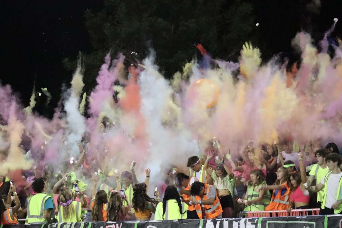 The+student+section+celebrating+with+neon+powder.