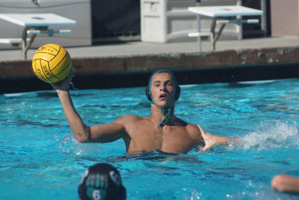 Water polo athlete completes a pass.