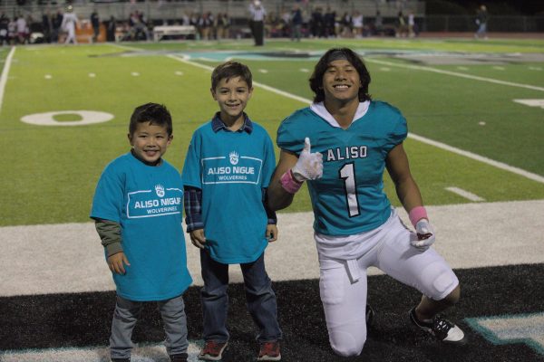 Marcus Macabitas (12) poses for a photo with children on community night.