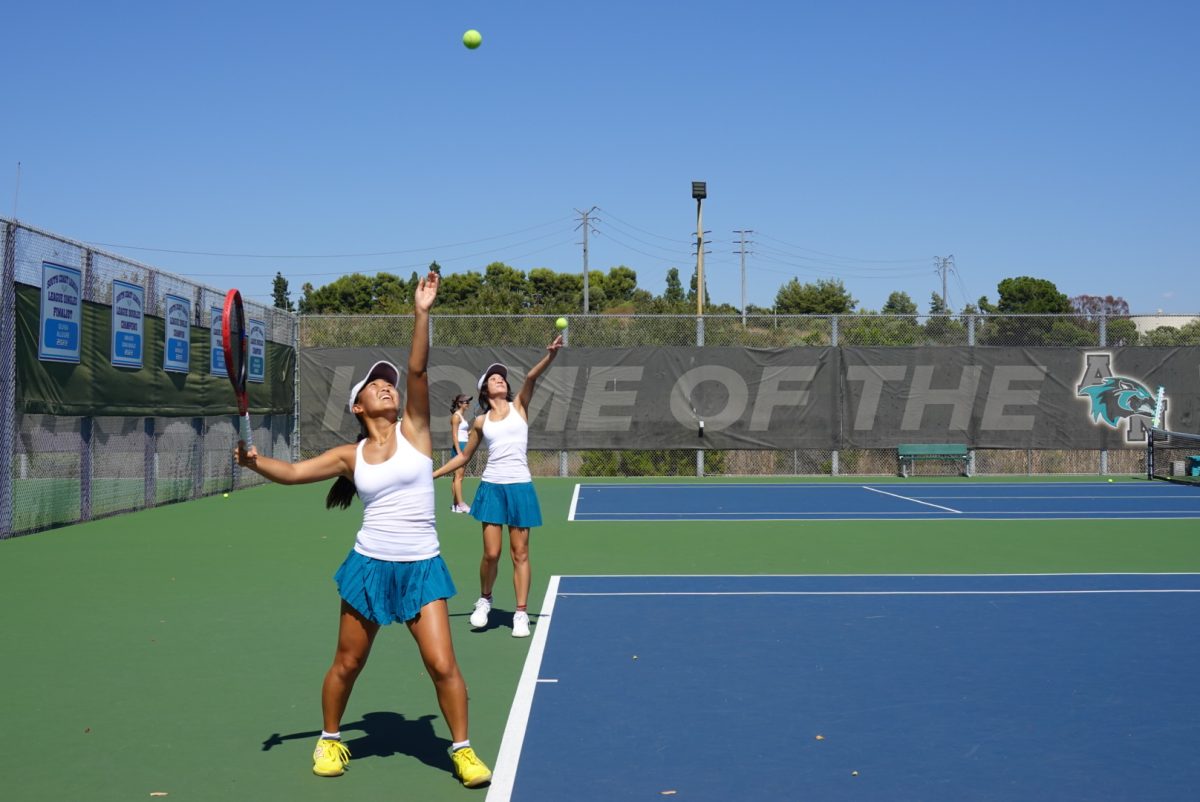 Ai Kato (10) serves the ball.