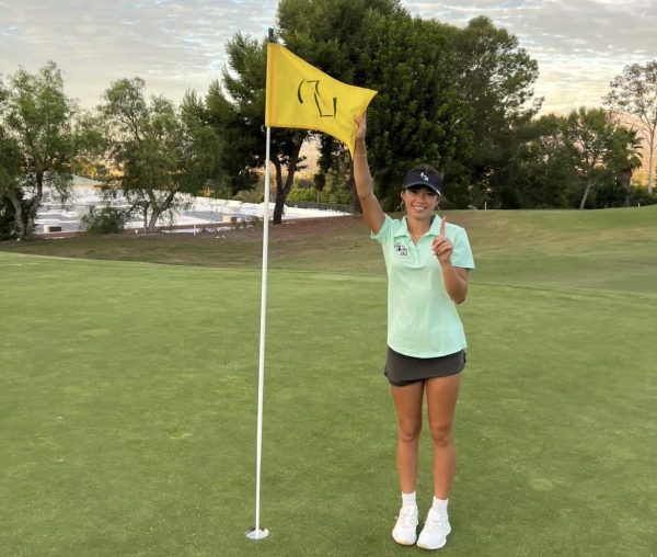 Rhyan Heine poses after a hole in one