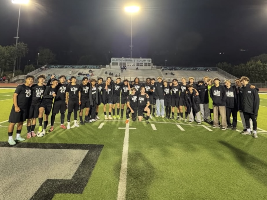 Boys soccer poses for a photo after a hard fought win